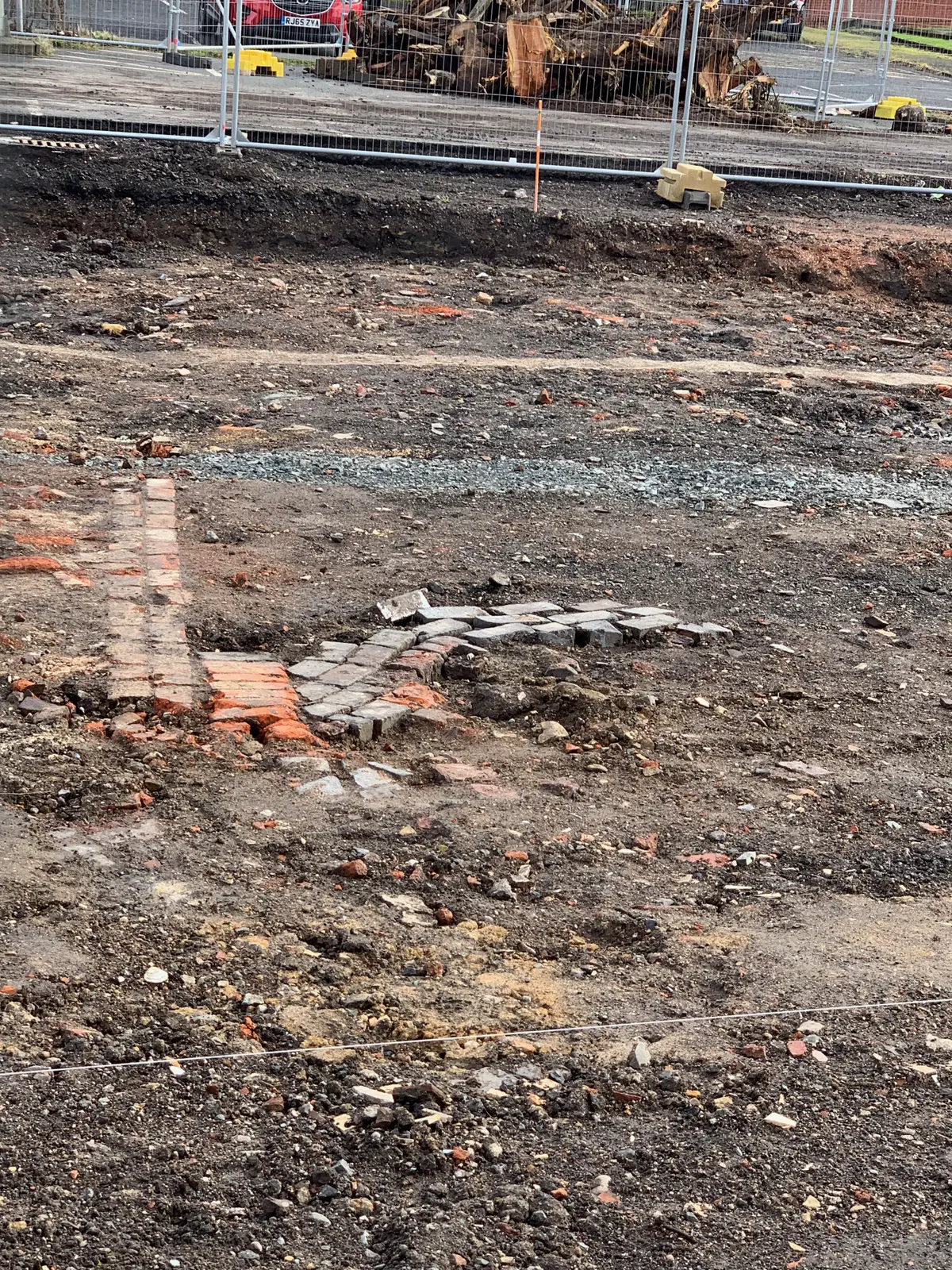 Here are a few pics from some Archeology taking place adjacent to Flood Street. Sadly the fencing wouldn't allow me closer to take better pictures. The excavations show the evidence of former back to back housing, floor tiling laid directly onto the earth, street or yard cobblestones, a coal hole/cellar and possibly a garden path? Then there's a mysterious line of embossed bricks. Tho' not to be seen there'd have been outside WC's.  All rather romantic as the past is often portrayed but such housing tended to create insanitary conditions with rising damp, open indoor fires & lack of ventilation.  - IMG_3702.jpg