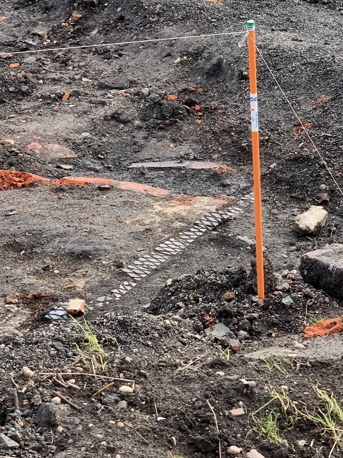 Here are a few pics from some Archeology taking place adjacent to Flood Street. Sadly the fencing wouldn't allow me closer to take better pictures. The excavations show the evidence of former back to back housing, floor tiling laid directly onto the earth, street or yard cobblestones, a coal hole/cellar and possibly a garden path? Then there's a mysterious line of embossed bricks. Tho' not to be seen there'd have been outside WC's.  All rather romantic as the past is often portrayed but such housing tended to create insanitary conditions with rising damp, open indoor fires & lack of ventilation.  - IMG_3703.jpg